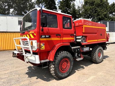 a red fire truck that is parked in a lot