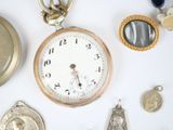 many different types of pocket watches on the table