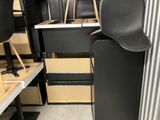 a black chair in the middle of a room