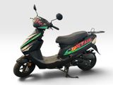 a scooter that is parked on a white surface