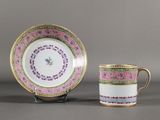 a cup and saucer sitting next to each other on a table