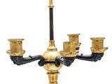 a black and gold candelier with four candles on it