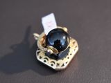 a picture of a ring with a black stone on it