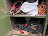 a green metal cabinet with a lot of wires and tools