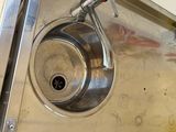 a stainless steel sink with a faucet attached to it