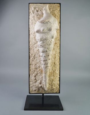 a sculpture of a woman standing on top of a wooden base