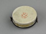 a small white bowl with a red design on it