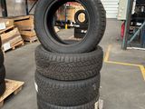 tires stacked on pallets in a warehouse with pallets in the background