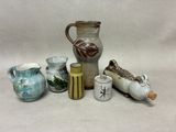many different types of vases sitting on a table