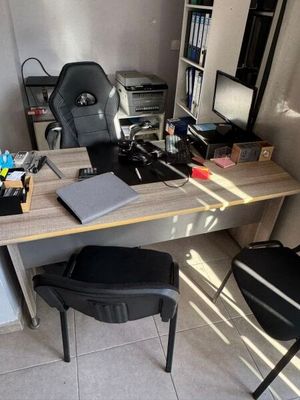 a desk with a chair and a computer on it