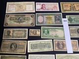 several different types of paper money sitting on a black surface