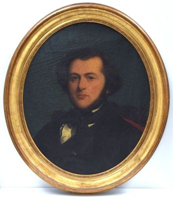 portrait of a man in a black coat and bow tie in a gold frame