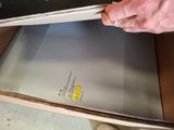 a man that is opening a box with a laptop in it