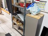 a small refrigerator in the corner of a room with shelves