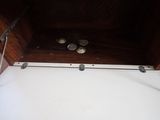 a wooden box with coins in it on the floor