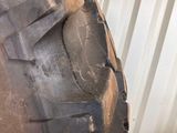 a tire that is sitting on the ground next to a wall