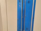 four blue lockers in a row in a room