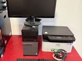 a desktop computer sitting on a red desk next to a printer