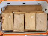 a box full of wood that is sitting on the floor