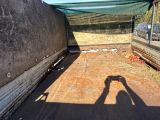 a shadow of a person taking a picture of the back of a truck