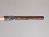 a close up of a wooden stick with a metal mesh on it