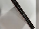 a close up of a tube of mascara on a white surface