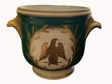 a green and gold vase with a bird on it