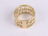 an image of a gold ring on a white surface