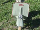 a scooter that is parked in the grass