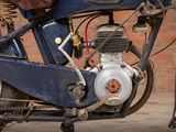 a close up of a motorcycle with a small engine on it