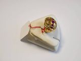 a gold ring with a purple stone on top of a napkin