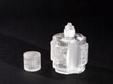 a small clear bottle with a white cap on a black surface