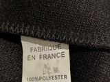 the label of a black jacket with a white tag on it