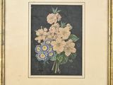 tableau représentant un bouquet de fleurs dans un cadre doré sur fond noir