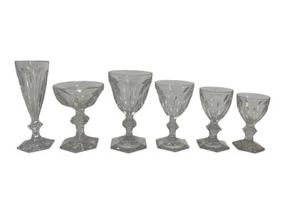 six glass goblets and a wine glass on a white background