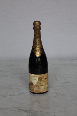 a bottle of champagne sitting on a marble counter top