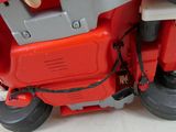 a red toy motorcycle that is sitting on the floor