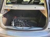 the back of a car with a bunch of wires in the trunk