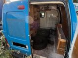 a blue van that is sitting in the grass