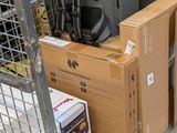 many suitcases and boxes on the floor in the store