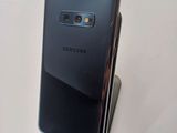 a close up of a cell phone on a stand on a table
