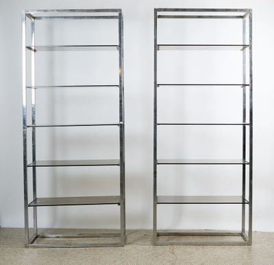 pair of chrome bookcases with glass shelves
