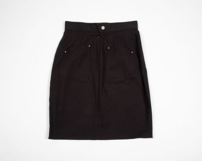 a black skirt on a hanger against a white background
