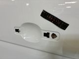 a sticker on the door handle of a white car