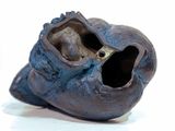 a close up of a shoe that has a hole in it