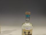 two small bottles of alcohol sitting on a table