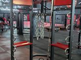 a gym area with a row of machines in it