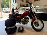 a red motorcycle that is parked in a showroom