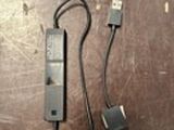 a picture of a cell phone and a charger on a table