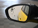 a side view mirror of a car with a broken window